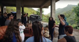 Amilcar Matos-Moreno, PhD candidate at the School of Public Health, gives directions to a group of students from the University of Michigan and Eastern Michigan University as they work to rebuild a house destroyed by Hurricane Maria.