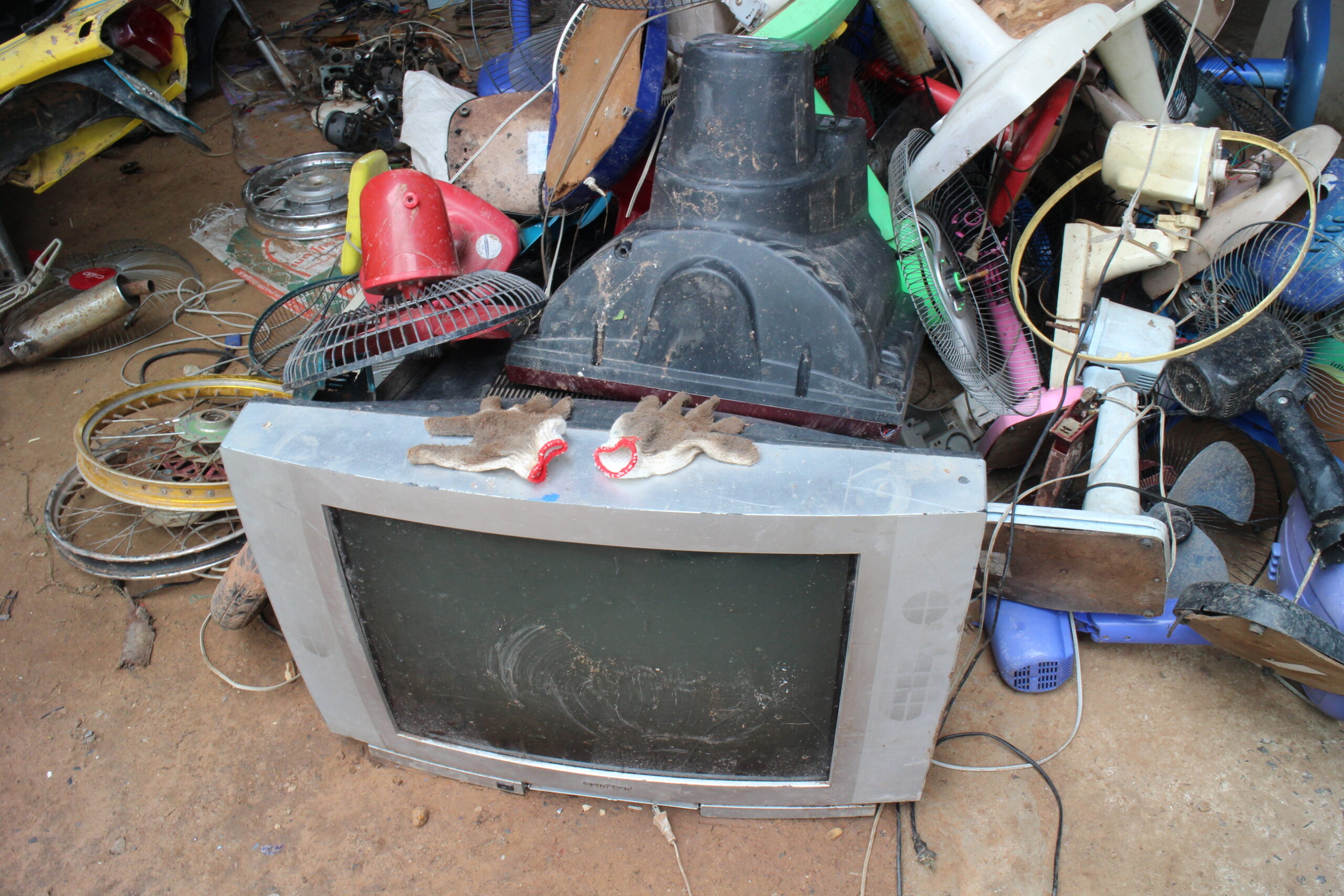 A pile of discarded electronic items that will be broken down to separate the valuable pieces within them.