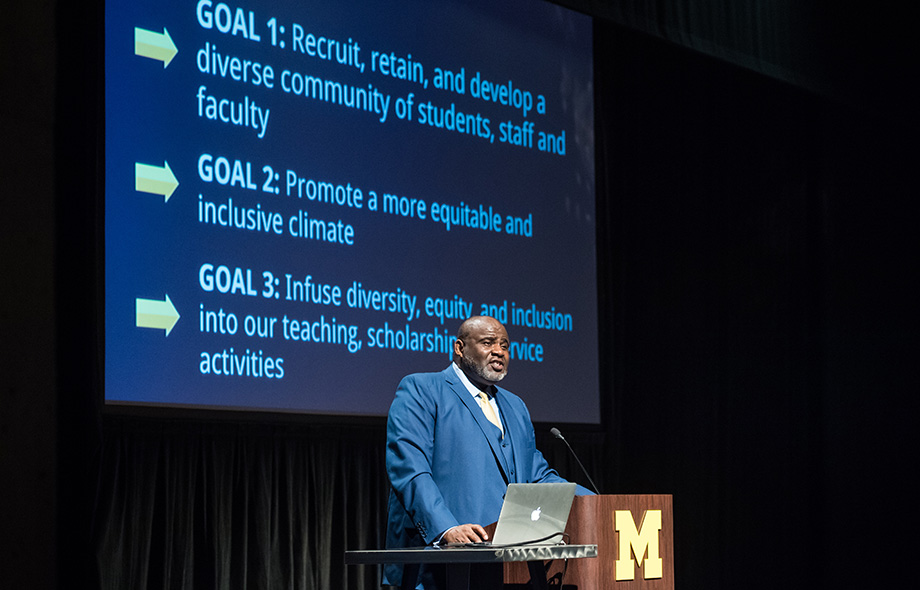 Photo of Robert Sellers outlining DEI progress with slide showing goals
