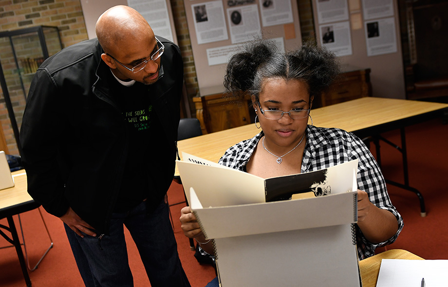 Associate Professor Stephen Ward and a student study archived materials