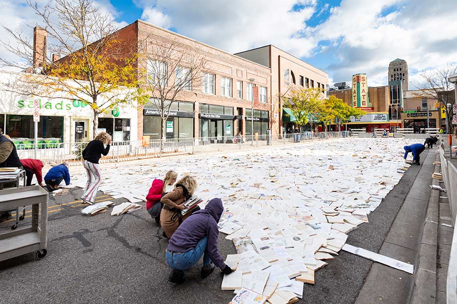 Photo of volunteers "paving" Liberty Street with books.