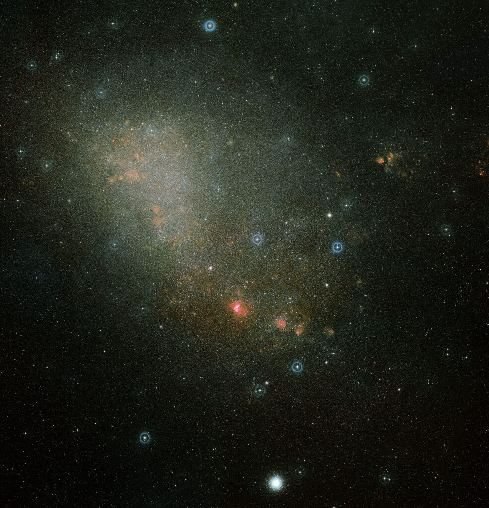 This image shows an overview of the full Small Magellanic Cloud and was composed from two images from the Digitized Sky Survey 2, which digitized photographic surveys of the night sky. Image credit: Davide De Martin (ESA/Hubble)