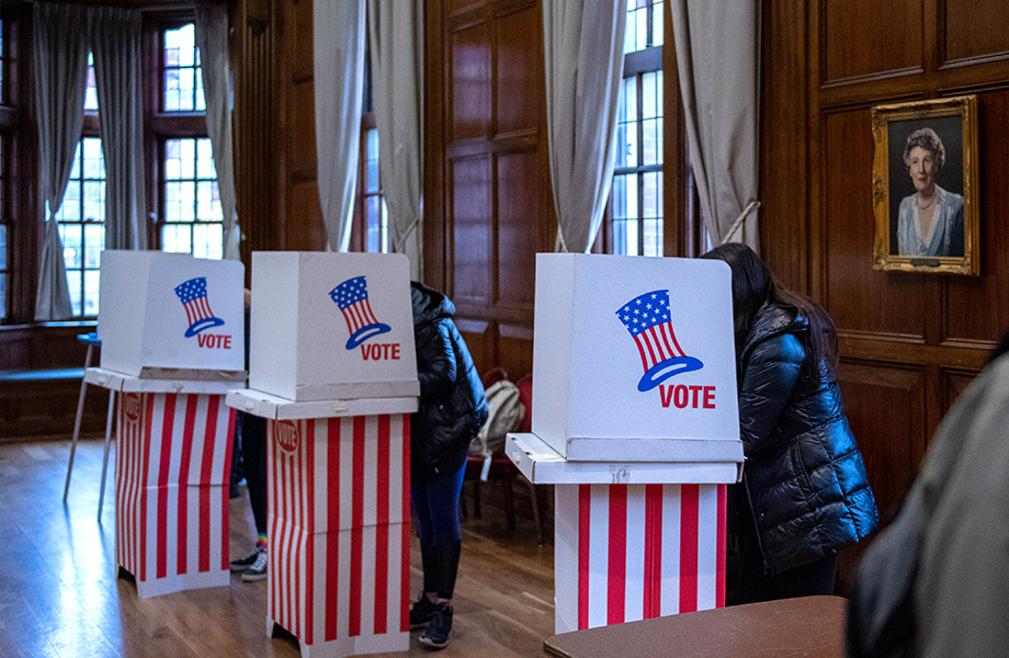 Photo of students casting ballots at voting booths