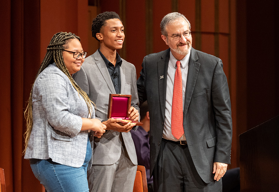 Photo of President Schlissel presenting the Wallenberg Medal to Rie'Onna Holmon and Ke'Shon Newman of B.R.A.V.E.