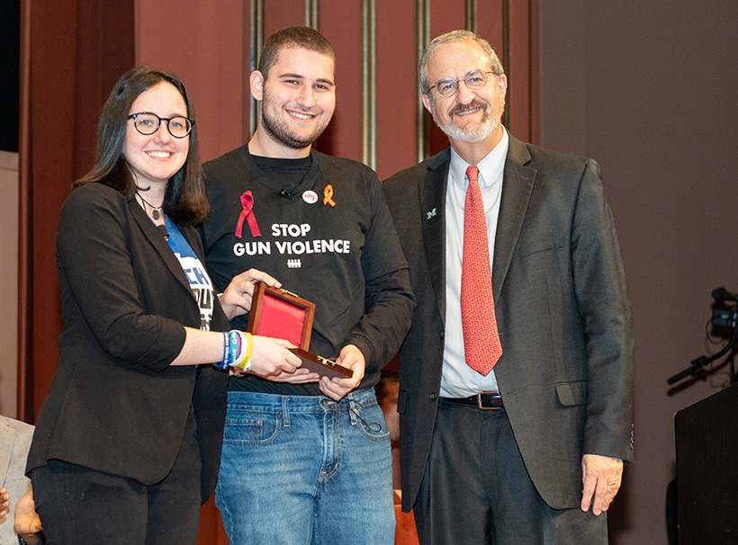 Photo of President Schlissel presenting the Wallenberg Medal to Sofie Whitney and Alex Wind of March For Our Lives