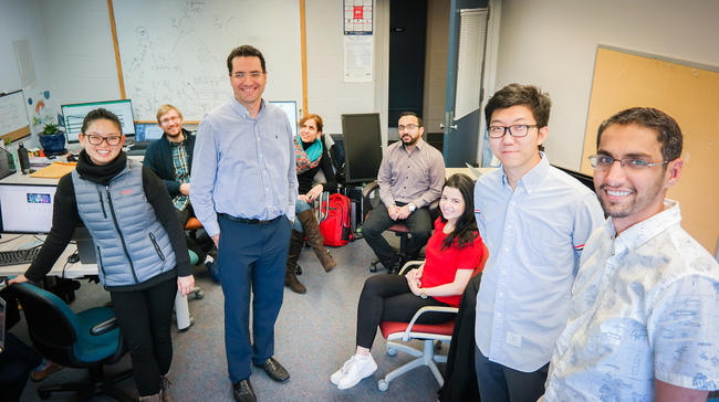 Photo of UM-Dearborn Associate Professor Marouane Kessentini, third from left, with his team of student researchers.