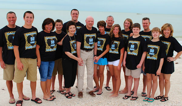 Bill and Pat Freehan pose on Barefoot Beach in Bonita Springs, Florida, with their family.