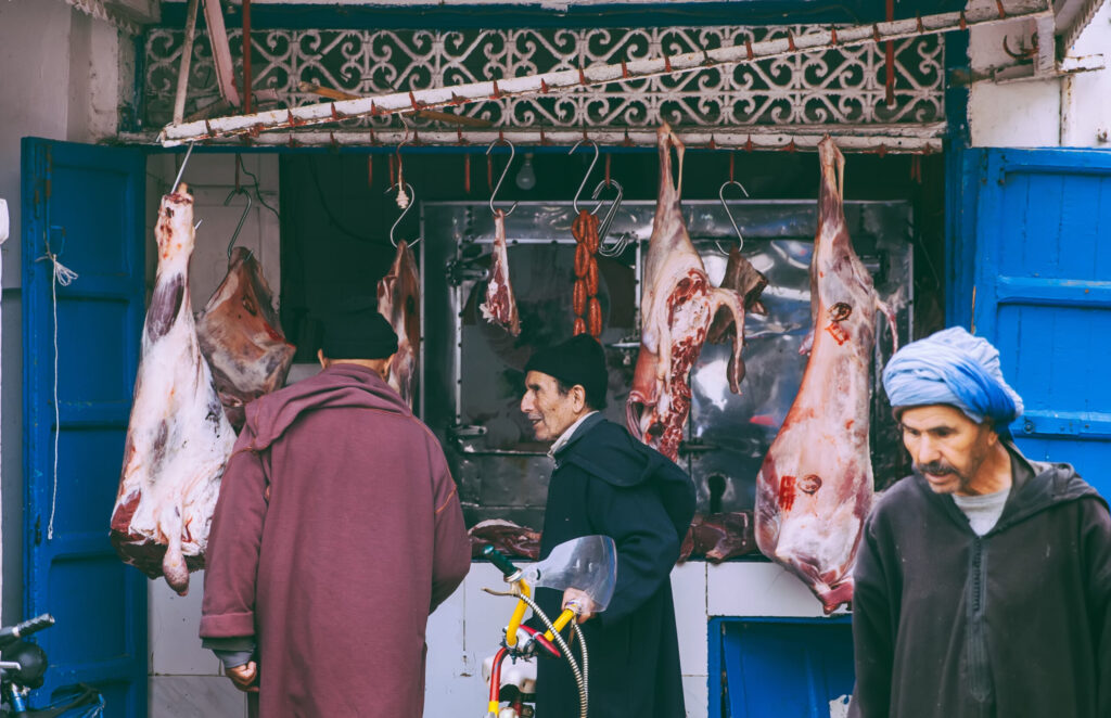 Customers buying foods at an open air meat market Morocco. Image credit: iStock