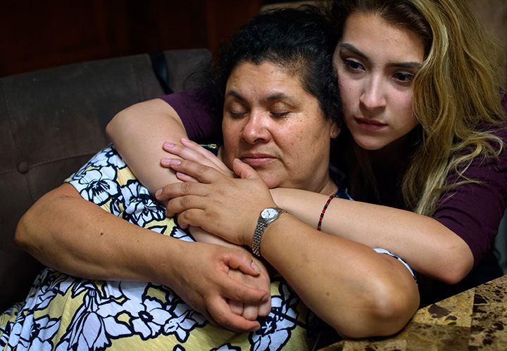 Photo of Lourdes Salazar Bautista (left) and her daughter Pamela Quintana-Salazar, 19, hold one another at a meeting with anti-deportation campaign leaders at Bautista’s Ann Arbor home.