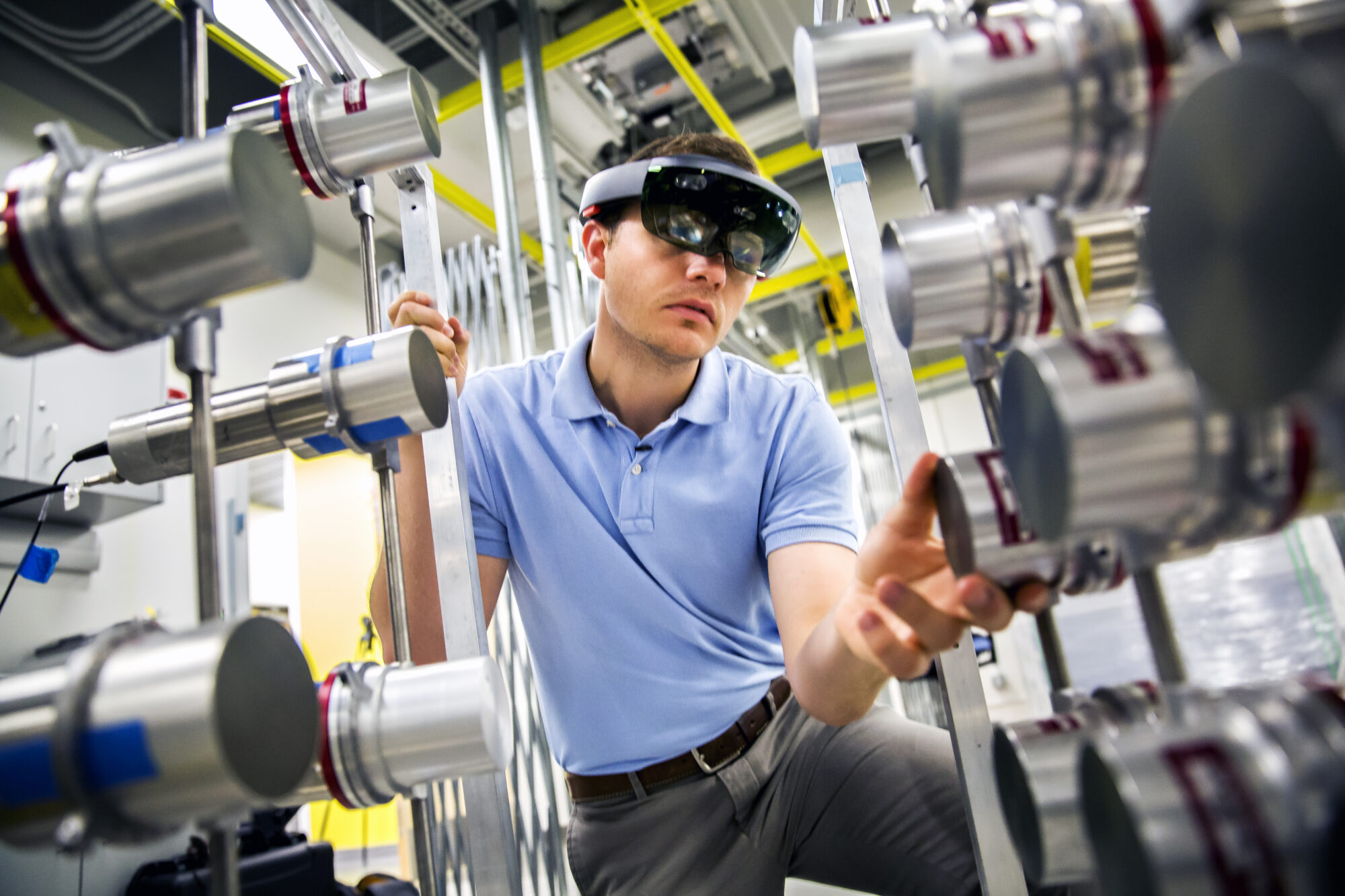 Michael Hamel, NERS Ph.D. Student, uses a Microsoft Hololens headset with a radiation imaging array to demonstrate the use of augmented reality to find nuclear materials hidden in a room. Image credit: Joseph Xu, Michigan Engineering