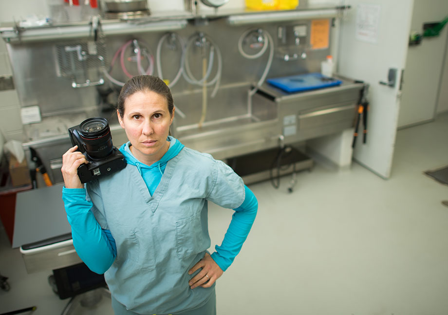 Photo of Lisa Belanger Neal with her camera in a lab