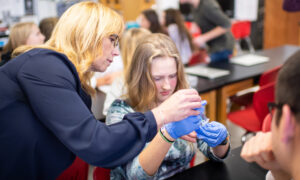 Racquel Huddleston helps 11th grader Ausable Kreiner with an experiment.