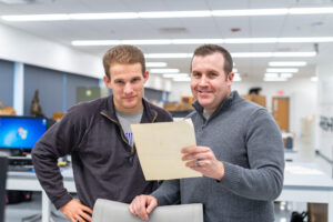 Clark Schmutz, left, and Cody Thompson examine a letter from the correspondence files of the Museum of Zoology mammal collections. Image credit: Scott Soderberg/Michigan Photography. 