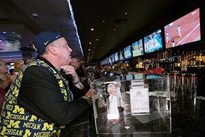 Derek Stevens, CEO and co-owner of the D Las Vegas, watches as Michigan takes on Loyola in the Final Four March 31, 2018, at the D.