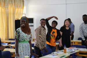 University of Cape Coast students and University of Michigan student, Caitlin Choi, laugh as they engage in an interactive exercise to learn about facilitator training. Image courtesy: U-M School of Nursing
