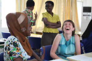 Mary Lewallen laughs with her Ghanaian colleague as they practice delivering Relationship Tidbits, a sexual violence primary prevention intervention adapted from the University of Michigan’s Relationship Remix. Image courtesy: U-M School of Nursing