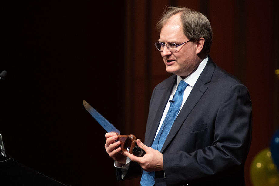 Photo of Mark Conger holding a saw
