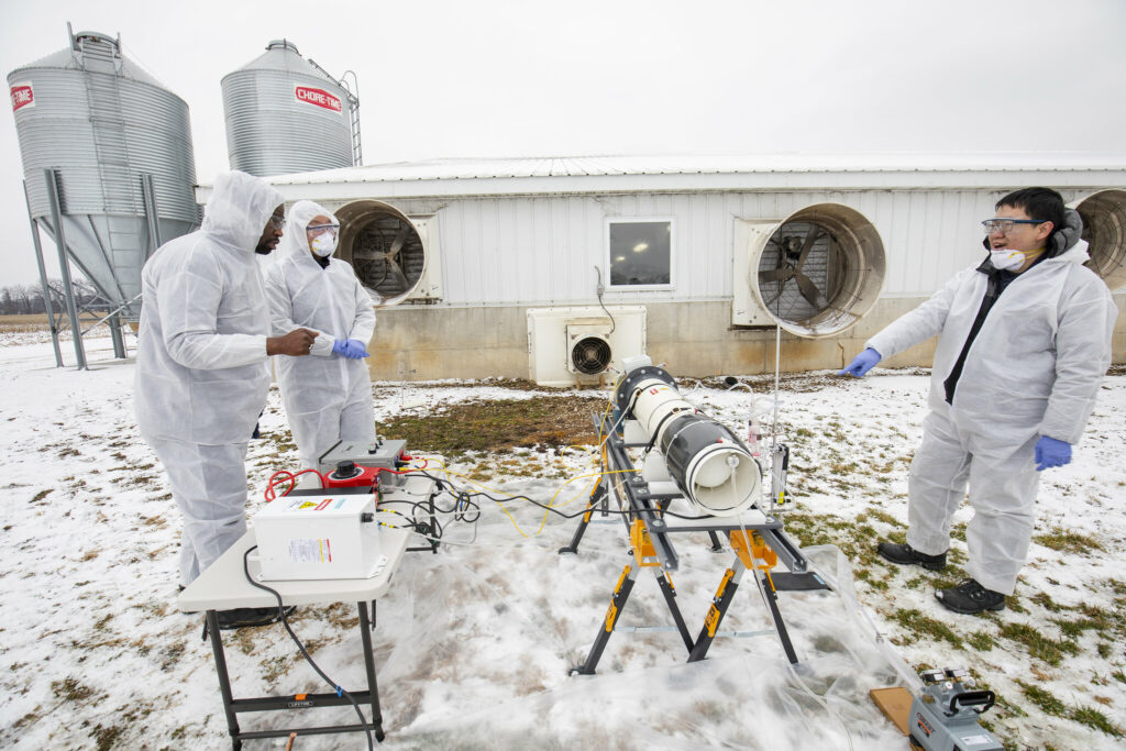 Civil and Environmental Engineering Professor Herek Clack (left) and members of his team set up a lab-scale non-thermal plasma device that has previously been proven to achieve greater than 99% inactivation of an airborne viral surrogate, MS2 phage, a virus that infects E.coli bacteria at the Barton Farms family pig farm in Homer, MI. Image credit: Robert Coelius/Michigan Engineering