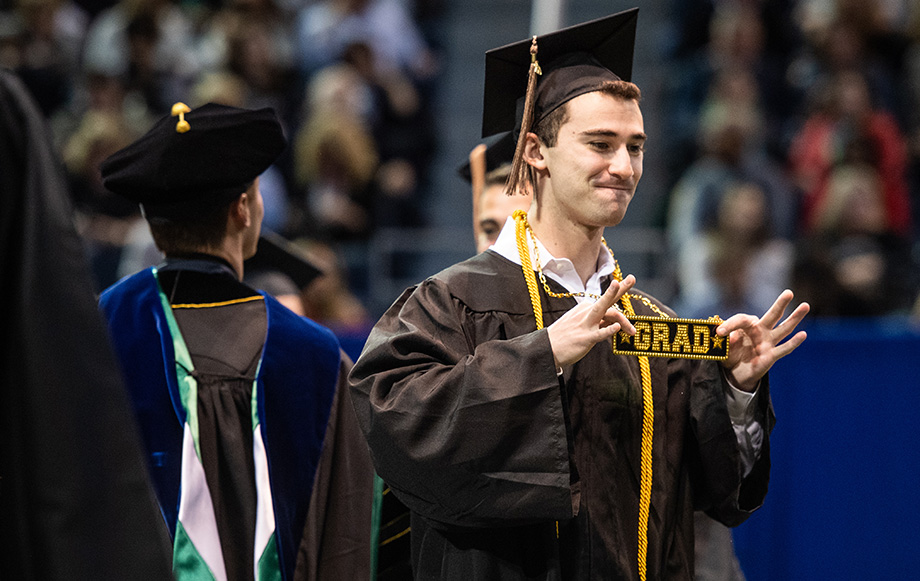 Photo of David Berger displaying graduation bling