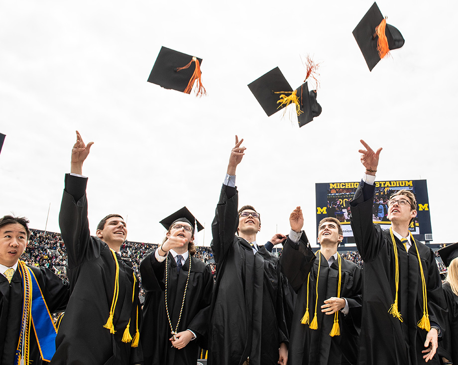 Photo of guys tossing hats