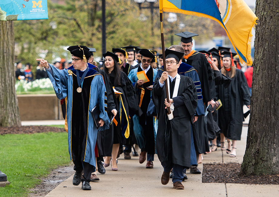 Photo of graduate procession from Rackham to Hill