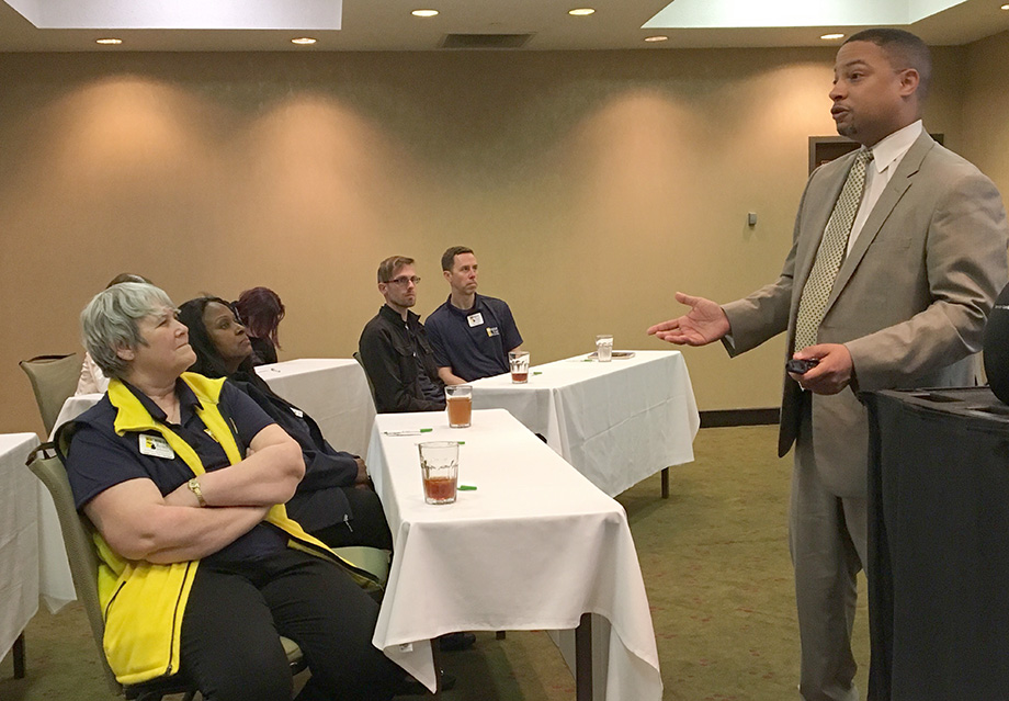 Photo of Mel Atkins II,&nbsp;executive director of community and student affairs for Grand Rapids Public Schools, talking with the Road Scholars