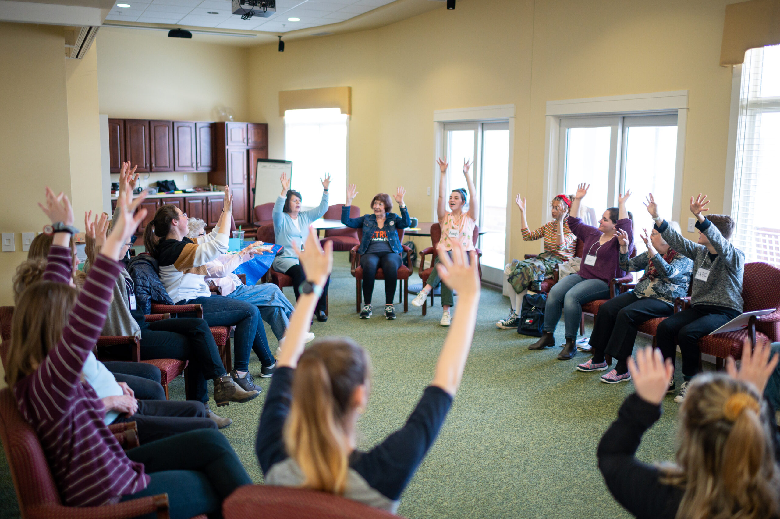 U-M students from Anne Mondro's Memory, Aging and Expressive Arts class University of Michigan Penny W. Stamps School of Art & Design work on a movement activity with participants at Brecon Village in Saline, MI. Eric Bronson/Michigan Photography.