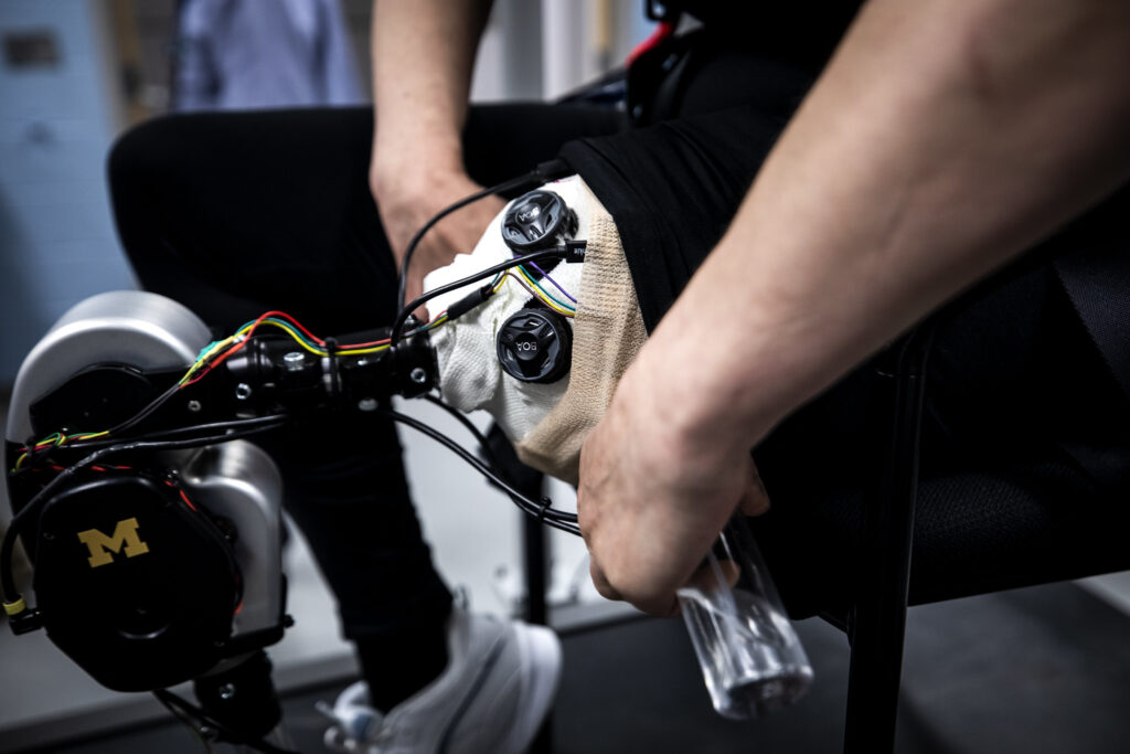 Dawn Jordan Musil tests an open-source robotic leg designed by Elliott Rouse, Assistant Professor of Mechanical Engineering, and his research group. Image credit: Joseph Xu, Michigan Engineering