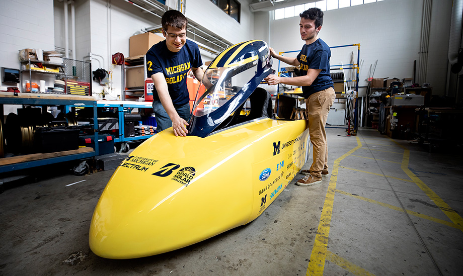 Photo of engineering students Andrew Dickinson, project manager, and Bassel Yassine, race mechanical engineer, installing the canopy on Electrum’s cockpit