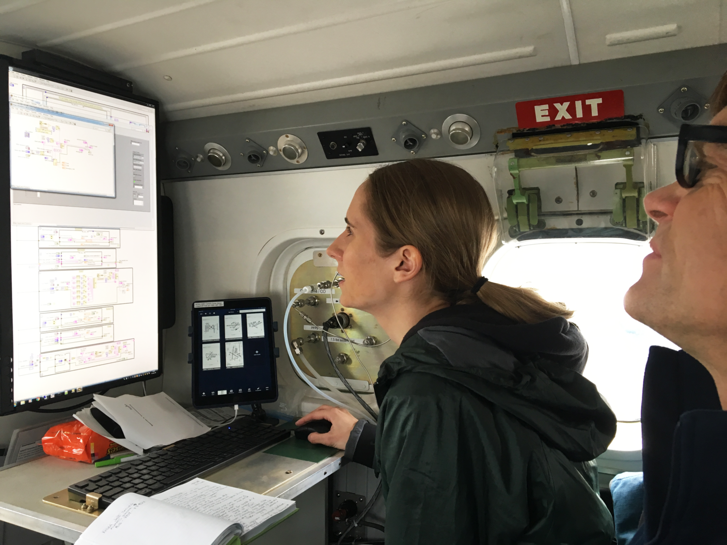 Genevieve Plant and Colm Sweeney review measurements of methane and other gases during an airborne research project in 2018. Image credit: Eric Kort, University of Michigan