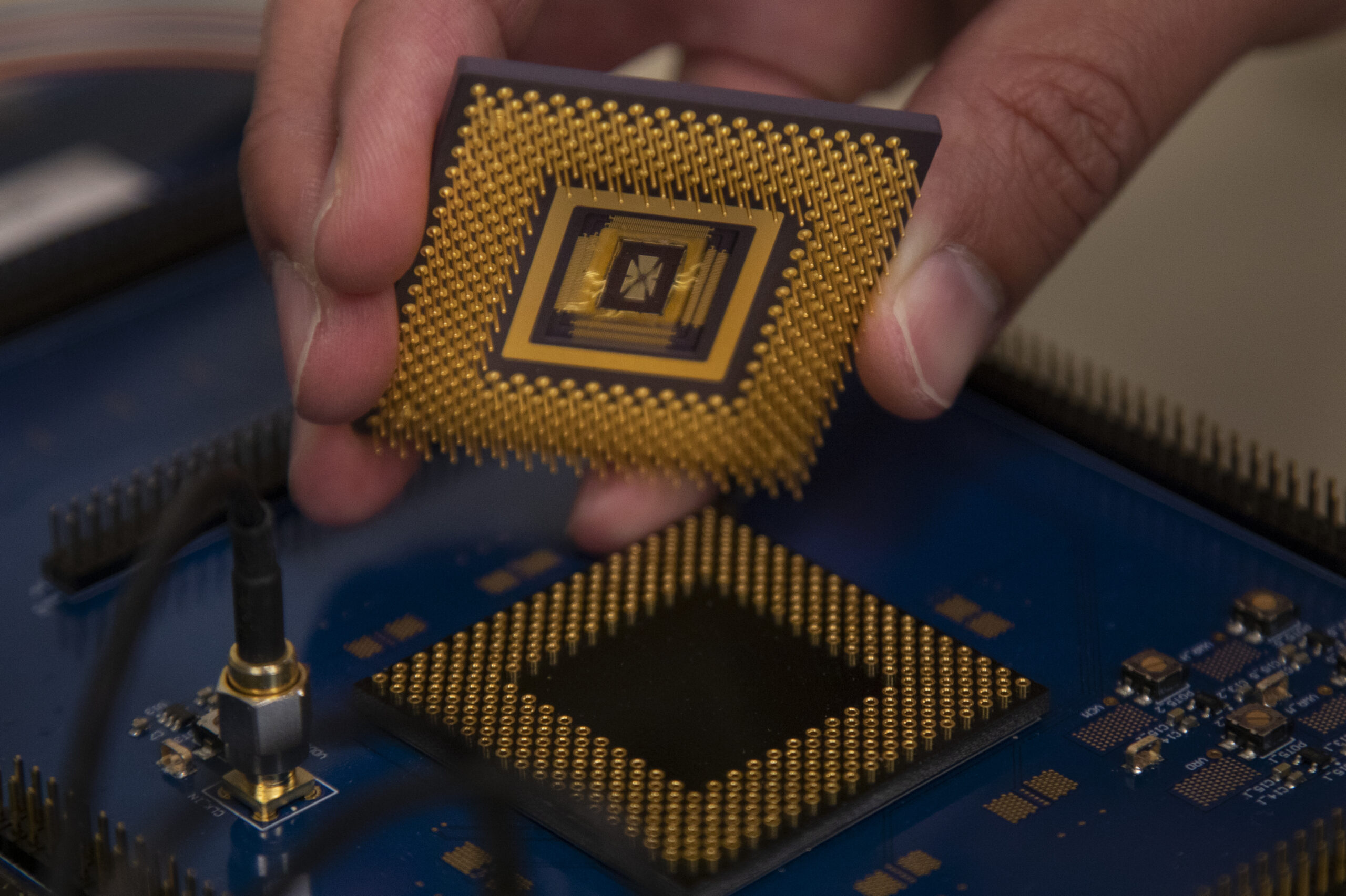The memristor array chip plugs into the custom computer chip, forming the first programmable memristor computer. The team demonstrated that it could run three standard types of machine learning algorithms. Image credit: Robert Coelius, Michigan Engineering