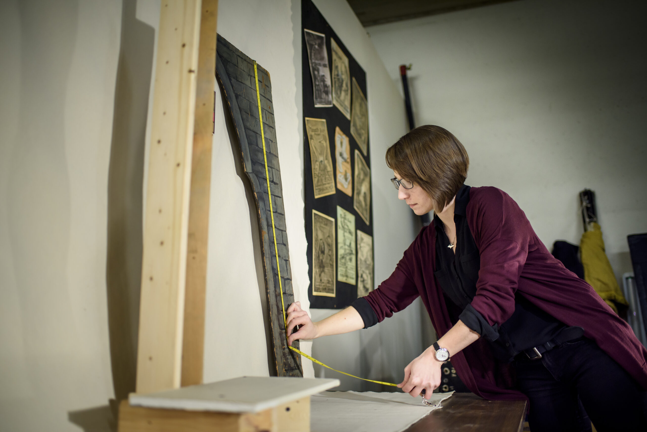 U-M alumna Hilary Severyn works to create a digital archive of Meredith Bixby's marionettes, props, and backdrops. Photo by Jeffrey M. Smith / University of Michigan School of Information.