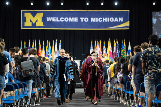 President Mark Schlissel and Joy Beatty, associate professor of management at UM-Dearborn and chair of U-M's Faculty Senate, lead the recessional from the News Student Convocation. 