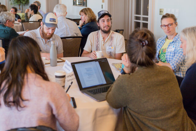 Photo of a group discussing one of the eight topics being addressed by internal analysis teams.