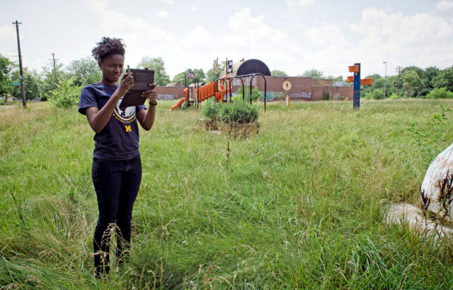 Former U-M student Jasmine Omeke photographs footpaths across an abandoned school yard in Detroit in 2013.