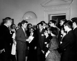 Robert Axelrod, a finalist in the Westinghouse Science Talent Search, with President John F. Kennedy in 1961. (Axelrod, with glasses, stands closest to Kennedy.) Mary Sue Coleman, who would become president of U-M, was another recipient on the same day. (Image: John F. Kennedy Presidential Library.)