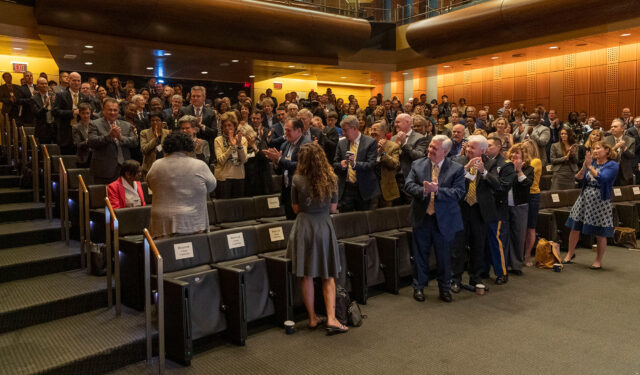 Photo of the audience applauding Vice President for Student Affairs E. Royster Harper.