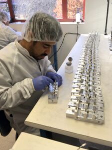 Technician Ahmed Alsadah assembles one of 7,300 robotic eyes produced at the University of Michigan.
