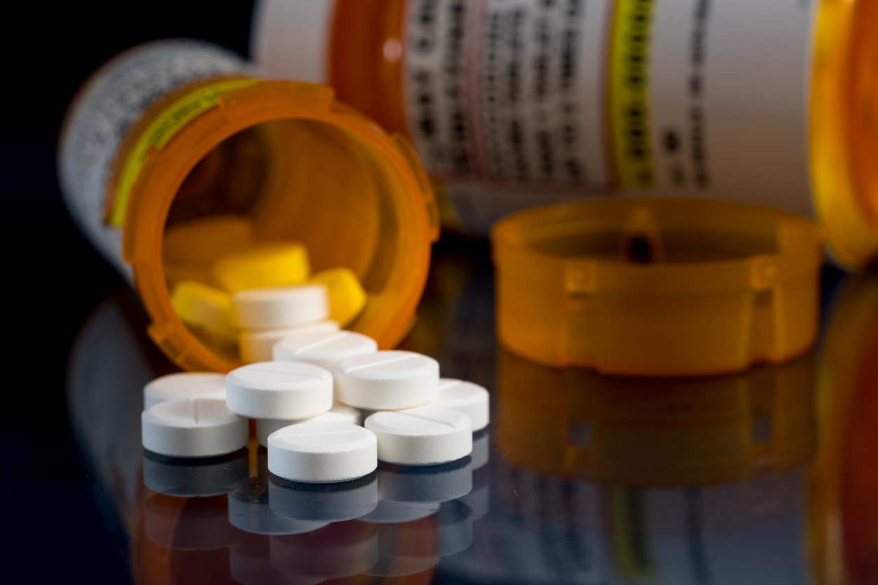 Oxycodone opioid tablets with prescription bottles. Image credit: iStock