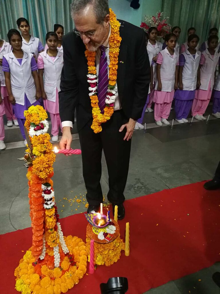 U-M President Mark Schlissel participates in a lamp lighting ceremony at Salokaya School of Nursing in Delhi for students entering the nursing profession.