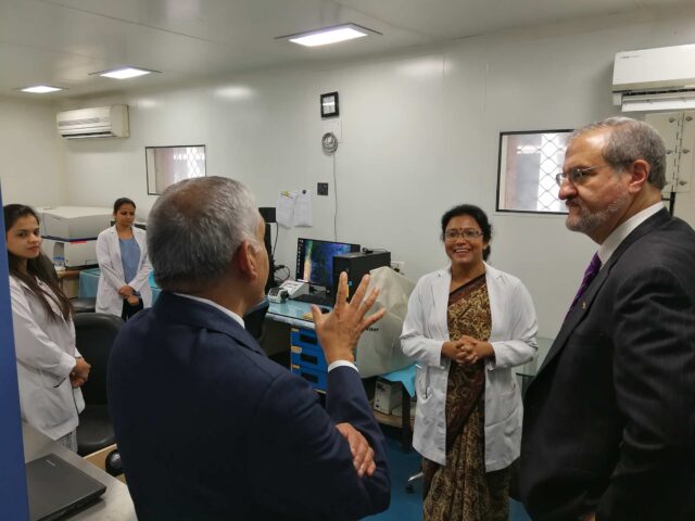 President Mark Schlissel talks with Krishnan Raghavendran (left), professor of surgery at Michigan Medicine, and Sujata Mohanty, of the Stem Cell Facility, All India Institute of Medical Sciences in New Delhi.