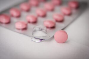 Pink pills in a blister pack. Image credit: StockSnap.io