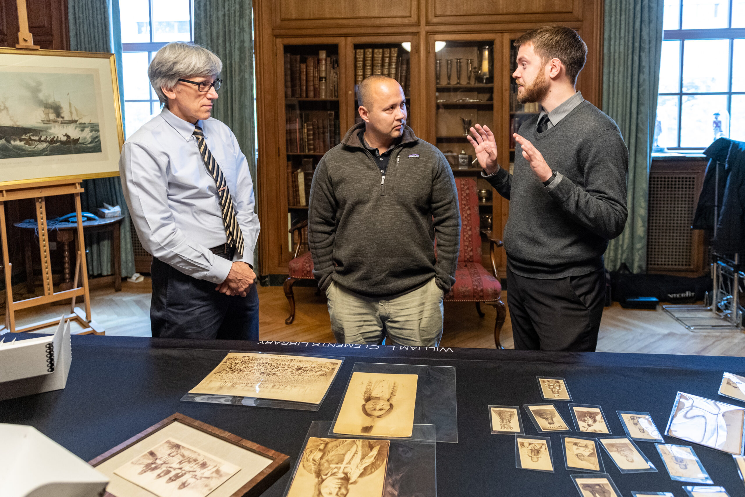 Left to right: Clayton Lewis, Eric Hemenway, and Jakob Dopp look at images from the Richard Pohrt Jr. Collection of Native American Photography at the William L. Clements Library. Image credit: Scott Soderberg, Michigan Photography
