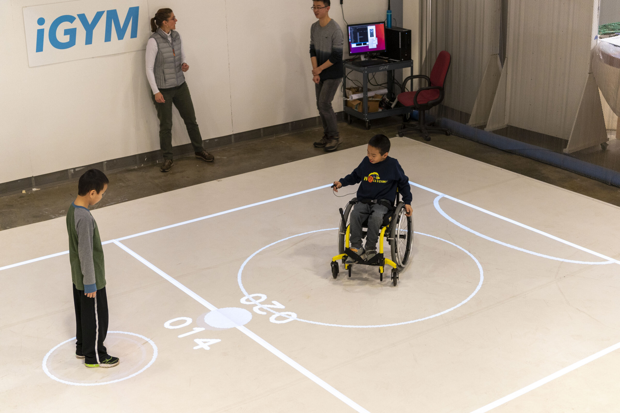 Darren Kreps (left) and his brother Bryan Kreps participate in a "play test" of iGym, an augmented reality system created by a multidisciplinary team at the University of Michigan that promotes inclusive play and exercise. Image credit: Roger Hart/Michigan Photography.