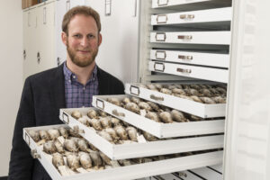 University of Michigan evolutionary biologist Benjamin Winger with some of the migratory songbirds used in a large study of avian responses to climate warming. Image credit: Roger Hart/University of Michigan Photography.