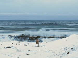 Waves break against the shore in the wintertime Arctic, leading to sea spray aerosols. Image credit: Kerri Pratt