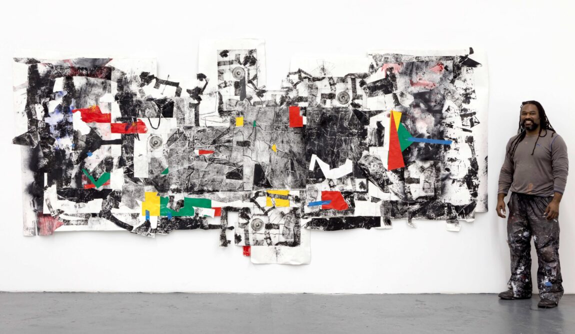 Artist Cullen Washington Jr. poses next to one of his abstract pieces.