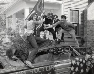 Students plant tree on car
