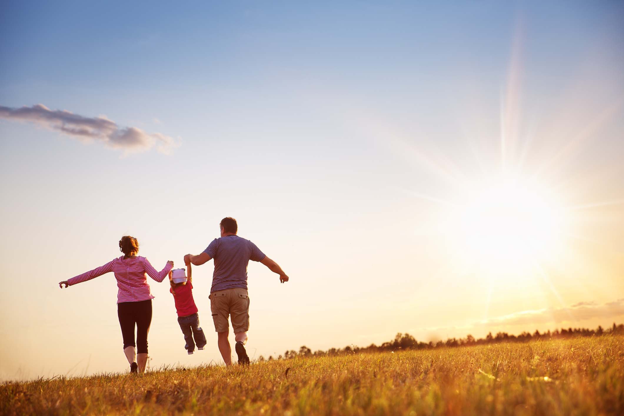 Image of couple with child having fun. Image credit: iStock