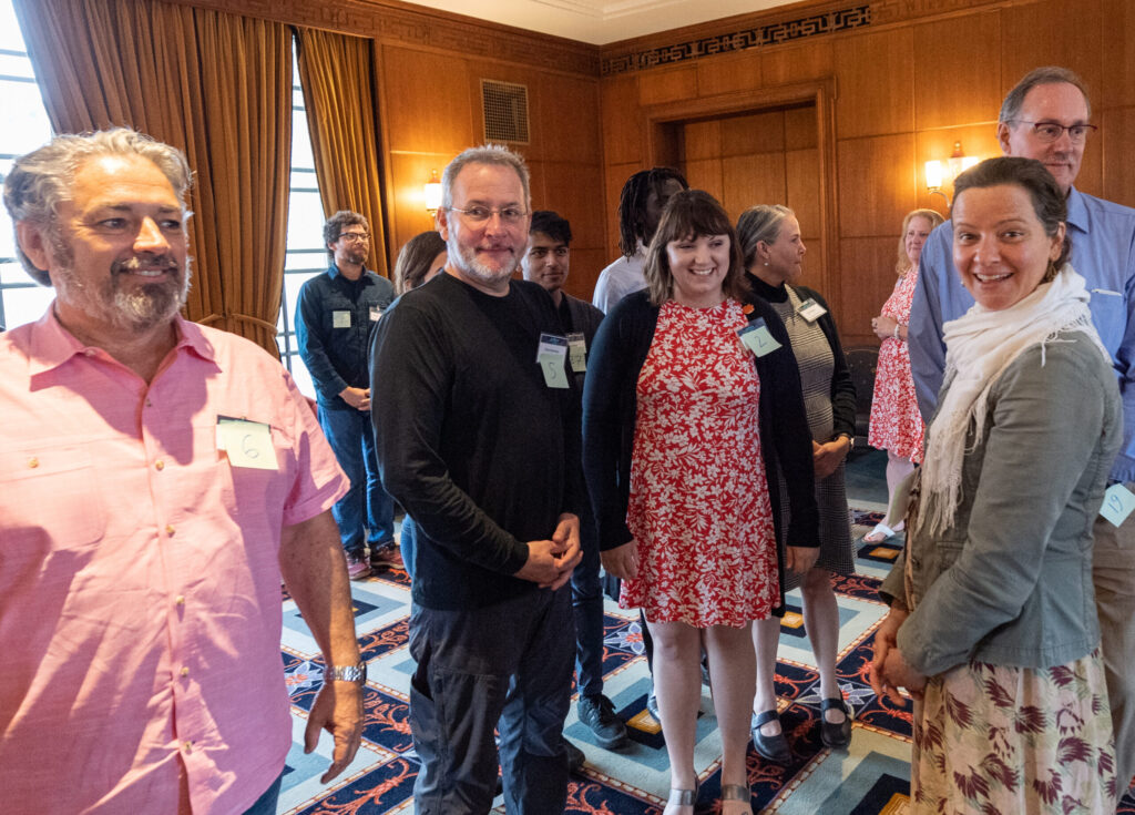 Master class co-leader and Ross/SEAS grad Sarah Hines of the U.S. Forest Service's Baltimore Urban Field Station looks on with amusement as participants engage in an on-your-feet activity enacting the principles of complex systems at the Galaxy 2019 Conference.